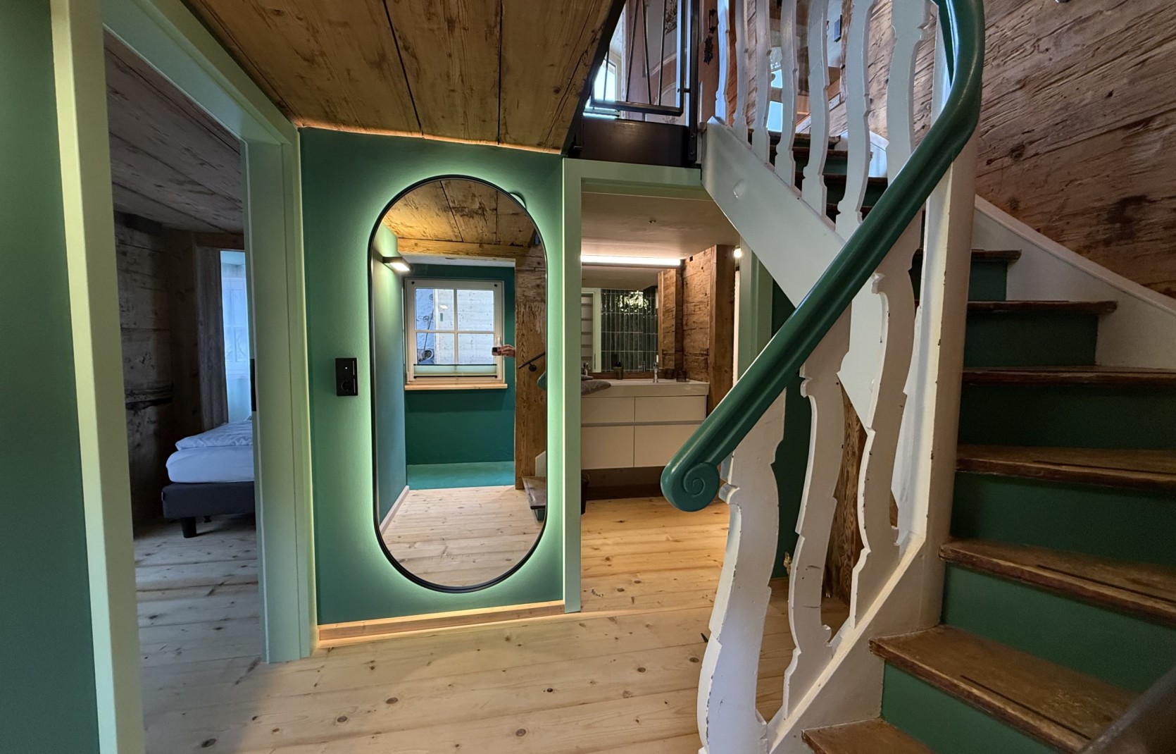 Eingangsbereich mit grünen Wänden und Altholz im Oswalda Hus Ferienhaus im Kleinwalsertal.